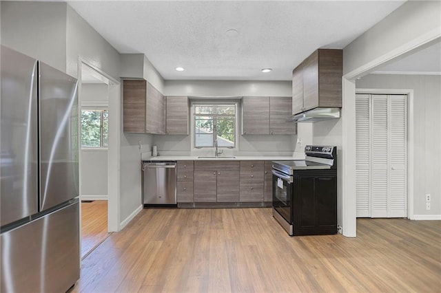 2215 Springdale Rd SW, Atlanta, GA 30315 - kitchen featuring appliances with stainless steel finishes, a sink, light countertops, baseboards, and wood finished floors