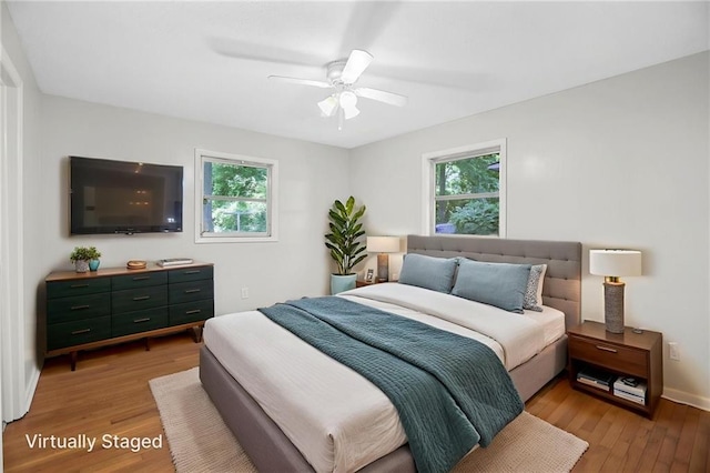 2215 Springdale Rd SW, Atlanta, GA 30315 - bedroom featuring multiple windows, light wood-style flooring, baseboards, and ceiling fan