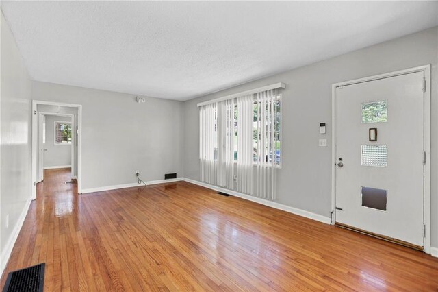 2215 Springdale Rd SW, Atlanta, GA 30315 - foyer featuring light wood finished floors, baseboards, and a textured ceiling
