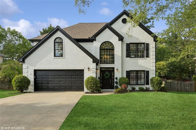 230 Bluff Oak Dr, Roswell, GA 30076 - french country home featuring concrete driveway, brick siding, fence, and a front yard