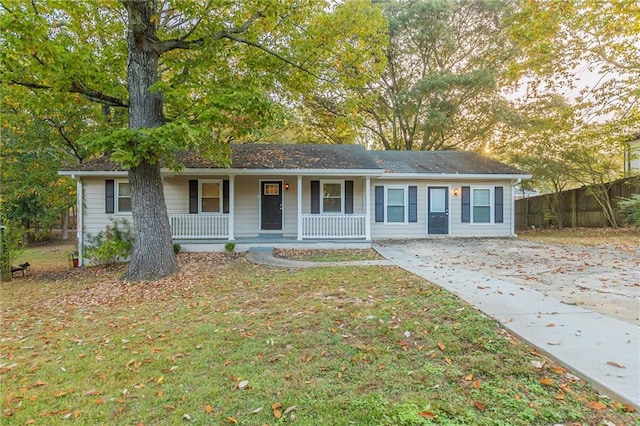 ranch-style house with a front lawn and covered porch