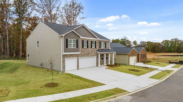 view of front facade featuring an attached garage, concrete driveway, stone siding, and a front yard