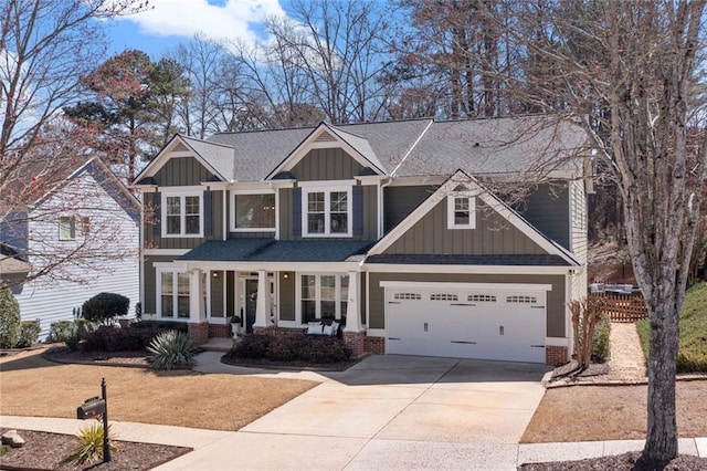 craftsman inspired home featuring a porch, board and batten siding, concrete driveway, an attached garage, and brick siding