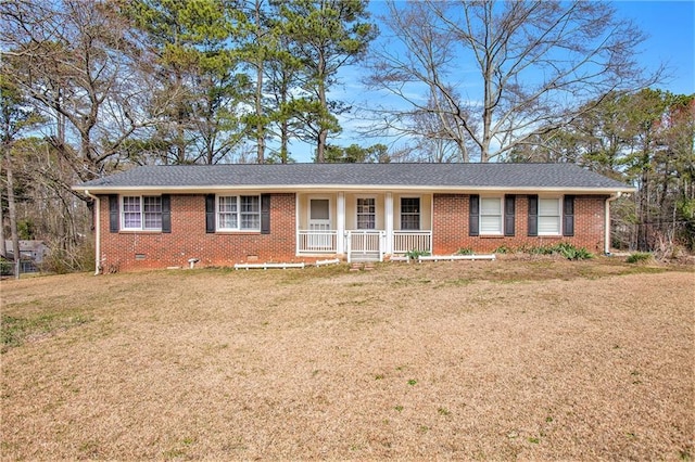 ranch-style home featuring crawl space, brick siding, a porch, and a front yard