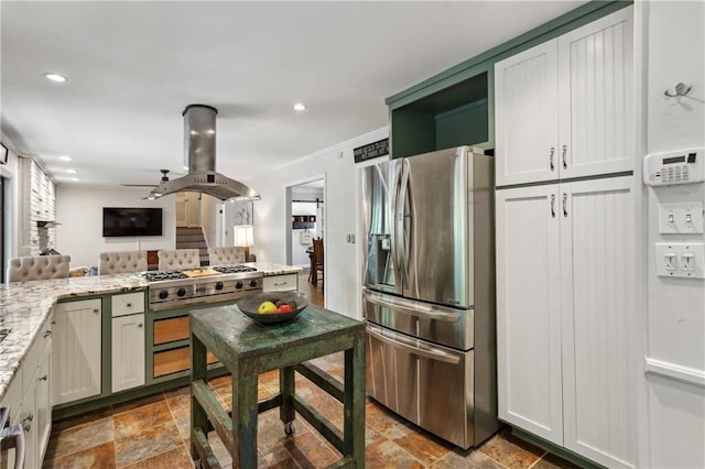 205 Glencourtney Dr, Sandy Springs, GA 30328 - kitchen featuring stainless steel appliances, island range hood, stone finish flooring, light stone countertops, and recessed lighting