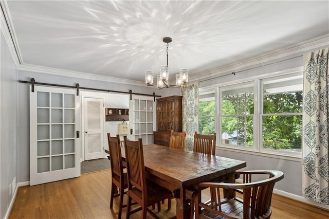205 Glencourtney Dr, Sandy Springs, GA 30328 - dining area featuring a barn door, baseboards, wood finished floors, a chandelier, and ornamental molding