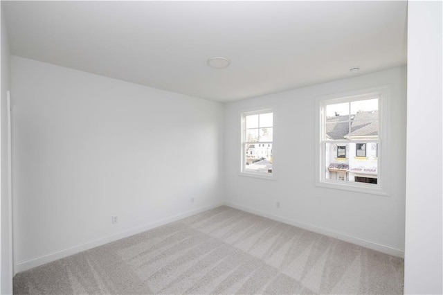 708 Dodd Ln Unit 156, Buford, GA 30518 - unfurnished bedroom featuring a walk in closet, visible vents, baseboards, and light carpet