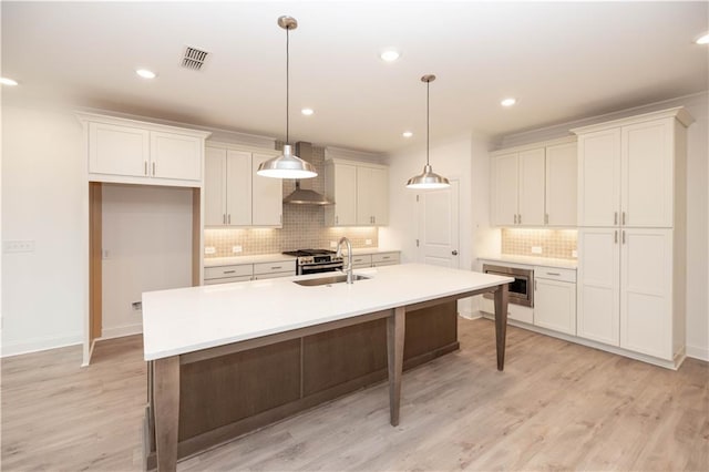 708 Dodd Ln Unit 156, Buford, GA 30518 - kitchen with a sink, visible vents, backsplash, white cabinetry, and an island with sink