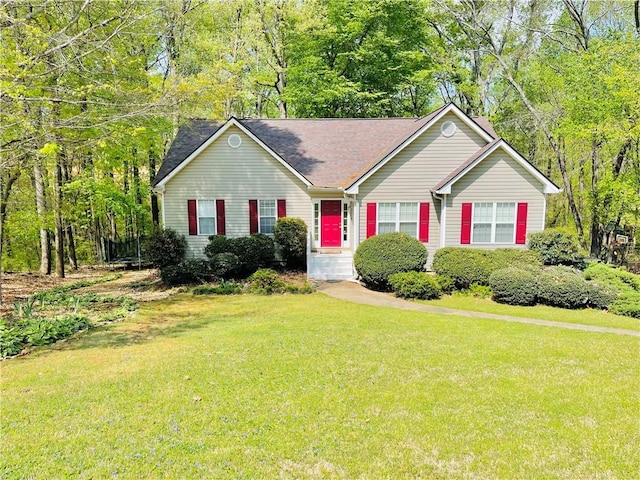 single story home with a shingled roof and a front lawn