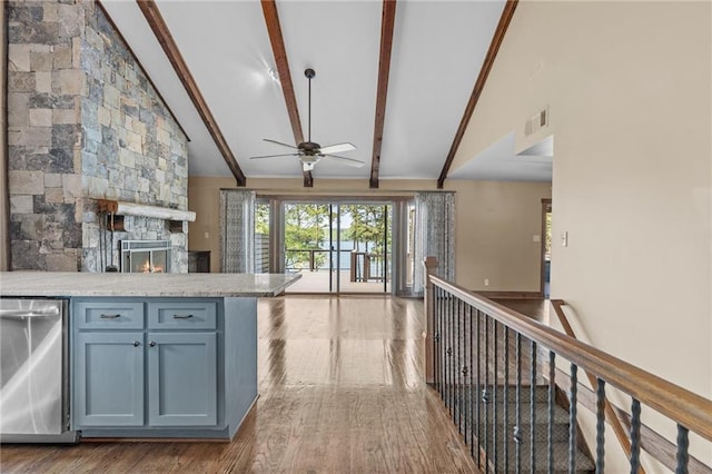 kitchen featuring open floor plan, visible vents, beam ceiling, ceiling fan, and wood finished floors