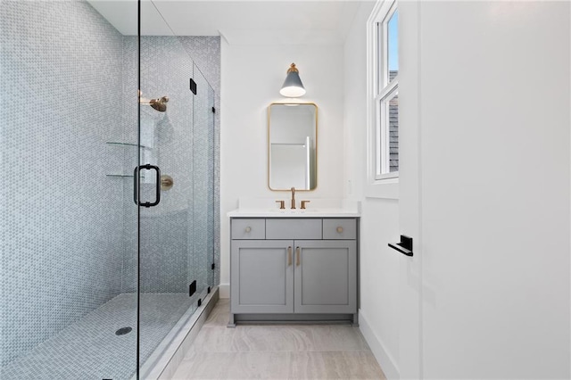 bathroom with a shower with door and vanity