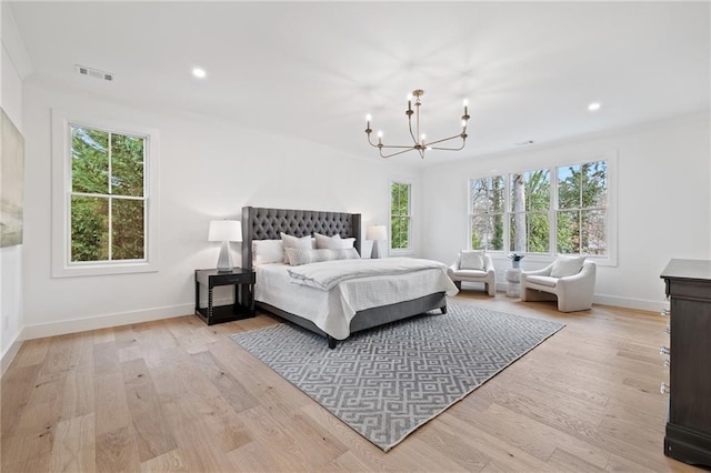 bedroom featuring a notable chandelier and light hardwood / wood-style floors