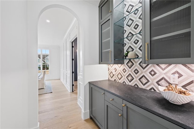 interior space with gray cabinetry, backsplash, and light hardwood / wood-style floors