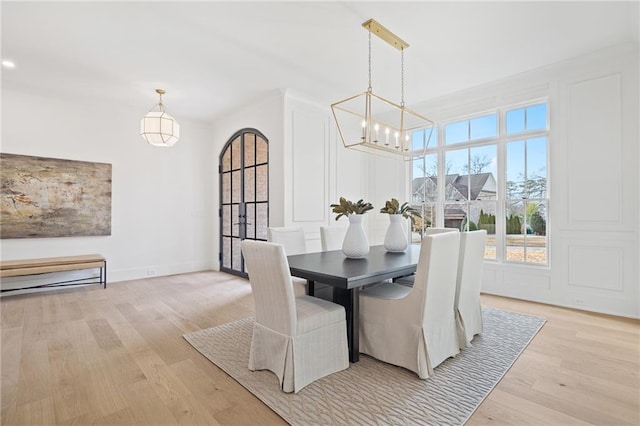 dining room with a notable chandelier and light wood-type flooring