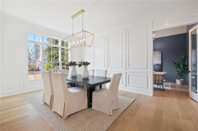 dining room with a chandelier and light wood-type flooring