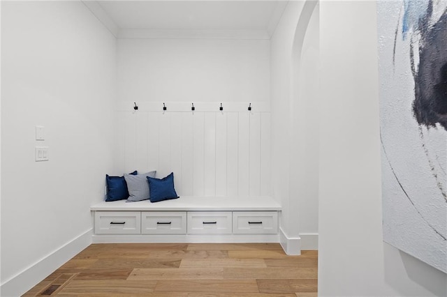 mudroom with crown molding and light hardwood / wood-style floors