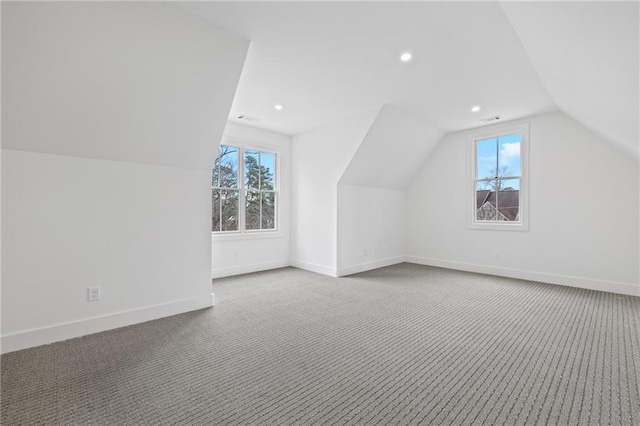 additional living space featuring lofted ceiling and carpet floors