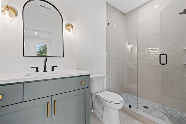 bathroom with tile patterned flooring, vanity, walk in shower, and toilet