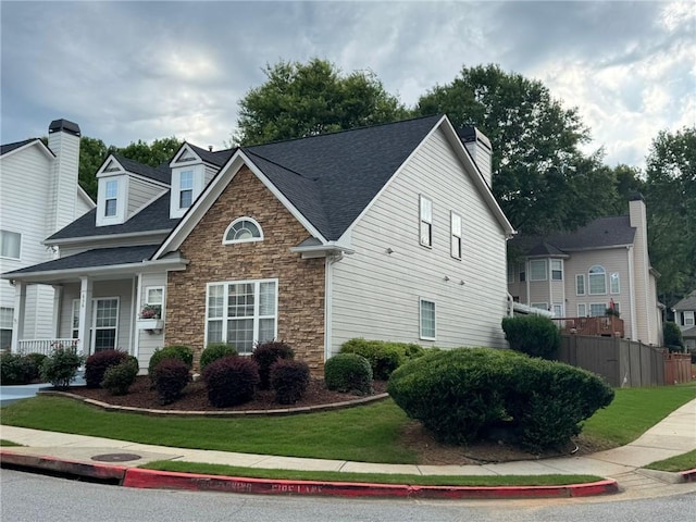 636 Lantern Park Ln, Scottdale, GA 30079 - view of front facade with stone siding, a chimney, and roof with shingles