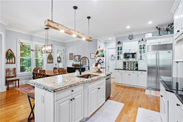 11 York Trce, Cartersville, GA 30121 - kitchen with stainless steel dishwasher, a sink, crown molding, open floor plan, and white cabinetry