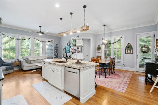 11 York Trce, Cartersville, GA 30121 - kitchen featuring stainless steel dishwasher, a sink, open floor plan, crown molding, and white cabinetry