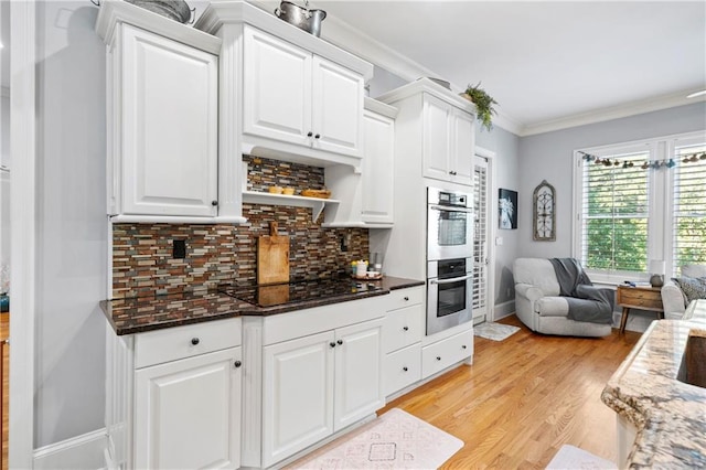 11 York Trce, Cartersville, GA 30121 - kitchen with black electric stovetop, stainless steel double oven, white cabinets, ornamental molding, and tasteful backsplash