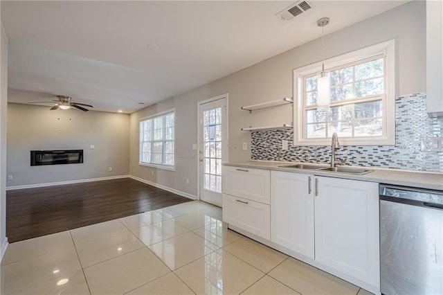 kitchen featuring dishwasher, light tile patterned flooring, white cabinetry, and pendant lighting