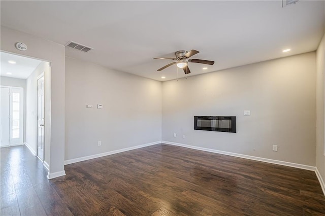 unfurnished living room with ceiling fan, dark hardwood / wood-style flooring, and heating unit