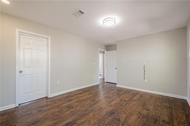 empty room with dark hardwood / wood-style floors