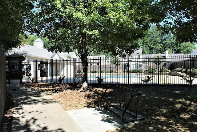 view of gate with a fenced in pool