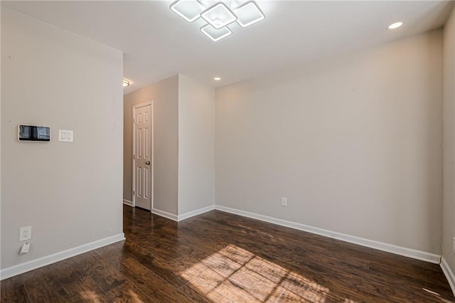 spare room with dark hardwood / wood-style flooring