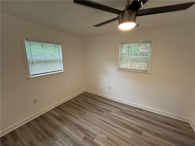 spare room featuring ceiling fan and dark hardwood / wood-style floors