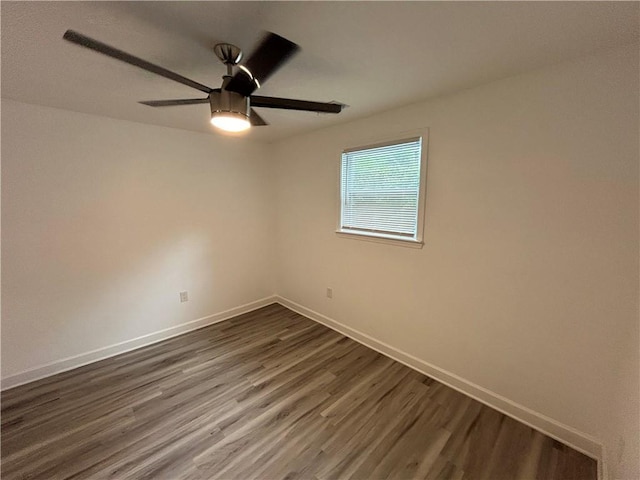 empty room featuring ceiling fan and dark hardwood / wood-style flooring