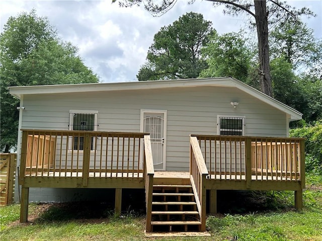 rear view of house with a wooden deck