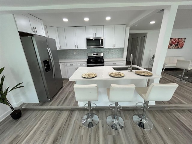 kitchen featuring appliances with stainless steel finishes, sink, and white cabinets