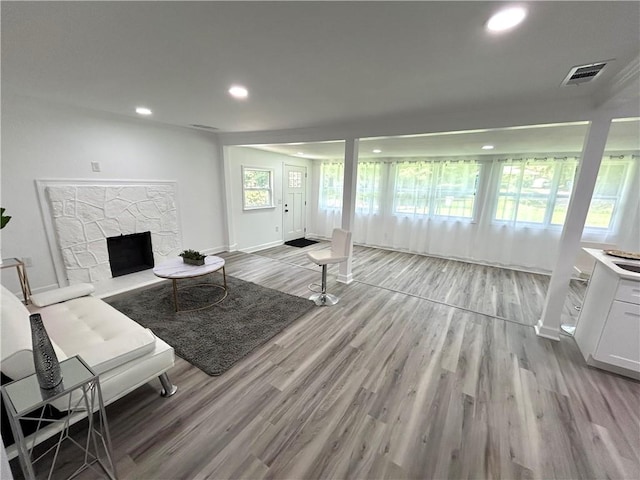 living room with a fireplace and light wood-type flooring