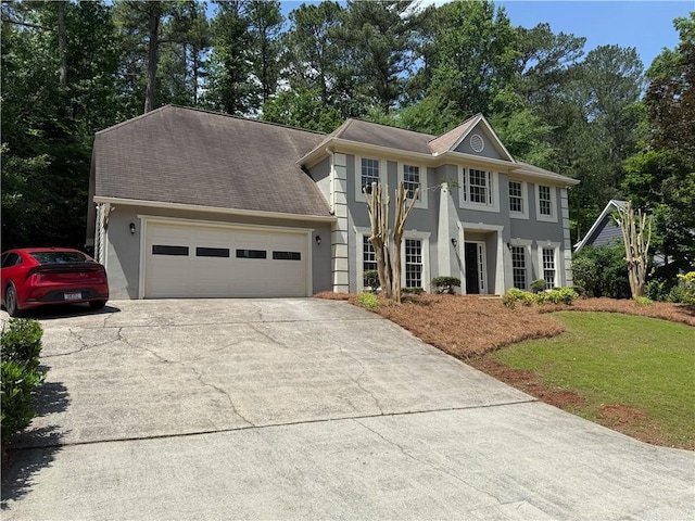 1368 Christiana Dr, Lawrenceville, GA 30043 - view of front of house with driveway, stucco siding, a garage, and a front yard