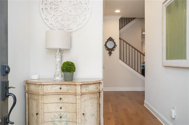 interior space featuring stairway, baseboards, wood finished floors, and recessed lighting