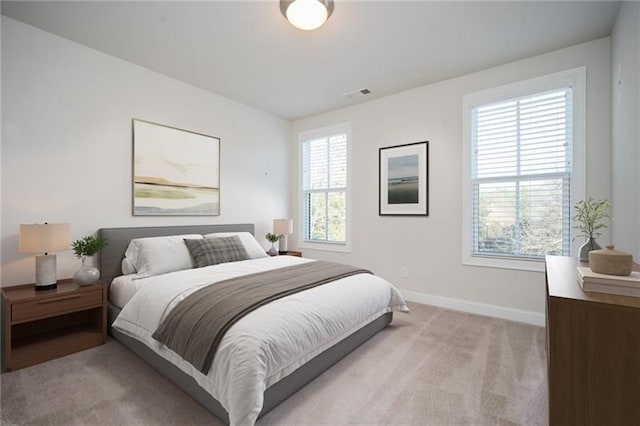 bedroom featuring light carpet, baseboards, and visible vents