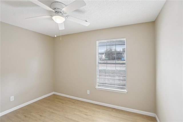 unfurnished room featuring a textured ceiling, ceiling fan, and light wood-type flooring