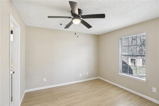 unfurnished room featuring ceiling fan, a textured ceiling, and light hardwood / wood-style flooring