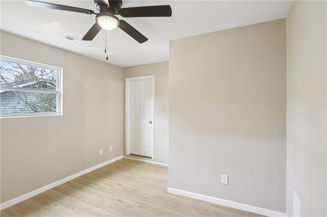 spare room featuring ceiling fan and light wood-type flooring