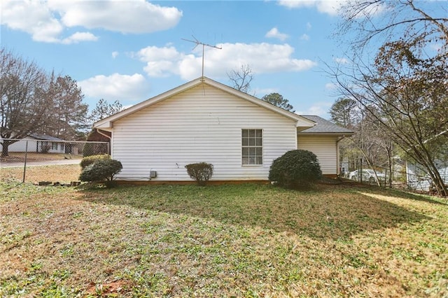 view of home's exterior with a lawn