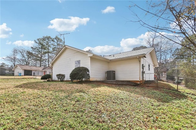 view of property exterior with a lawn and central air condition unit