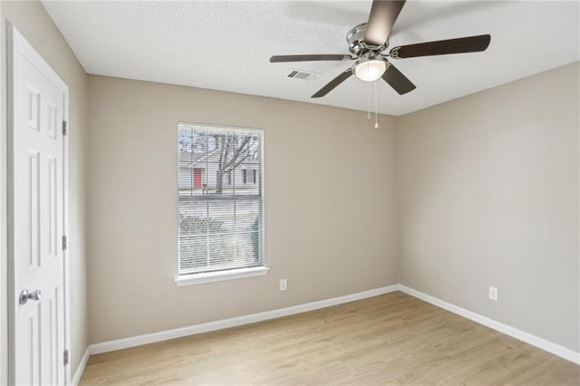 spare room featuring ceiling fan and light hardwood / wood-style flooring