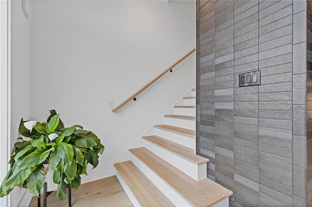 stairs featuring hardwood / wood-style flooring