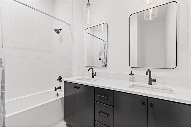 bathroom with vanity and tiled shower / bath combo