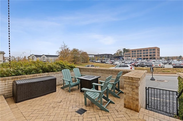 view of patio / terrace featuring an outdoor fire pit