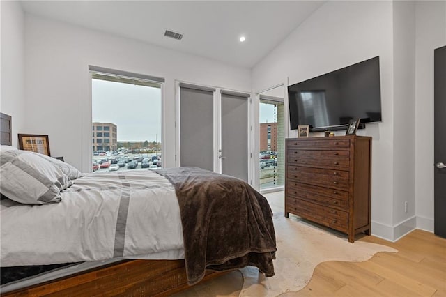 bedroom featuring light hardwood / wood-style flooring and multiple windows