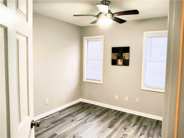 spare room featuring dark hardwood / wood-style floors, a wealth of natural light, and ceiling fan